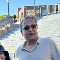 Kal Raman with a stadium in the background.