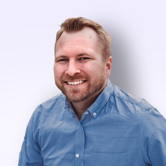 Clay Roop wearing a blue shirt and smiling for the camera