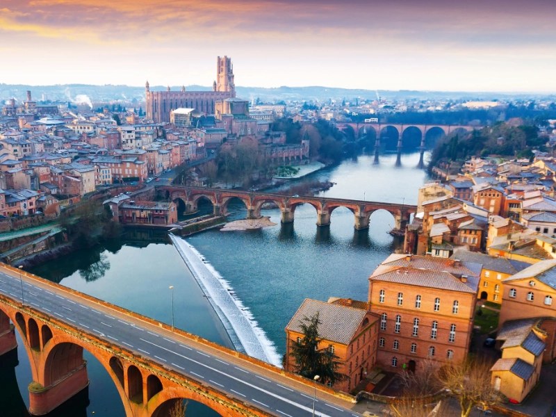 A city landscape with a river, bridges, and buildings