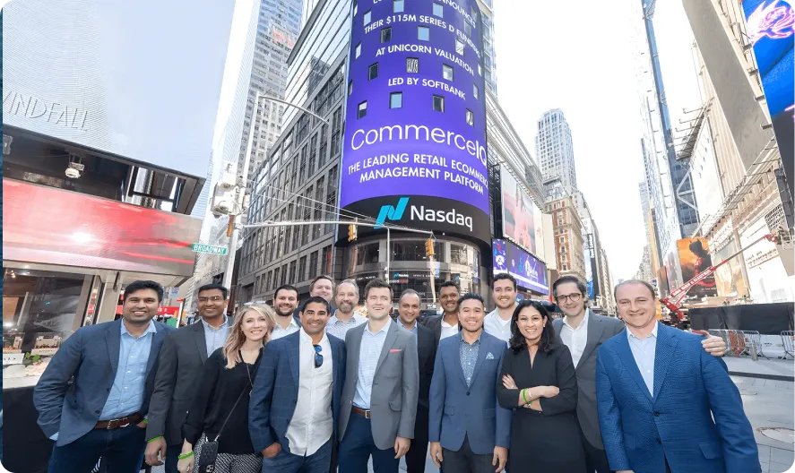 CommerceIQ team in front of Nasdaq billboard in Times Square, New York City.