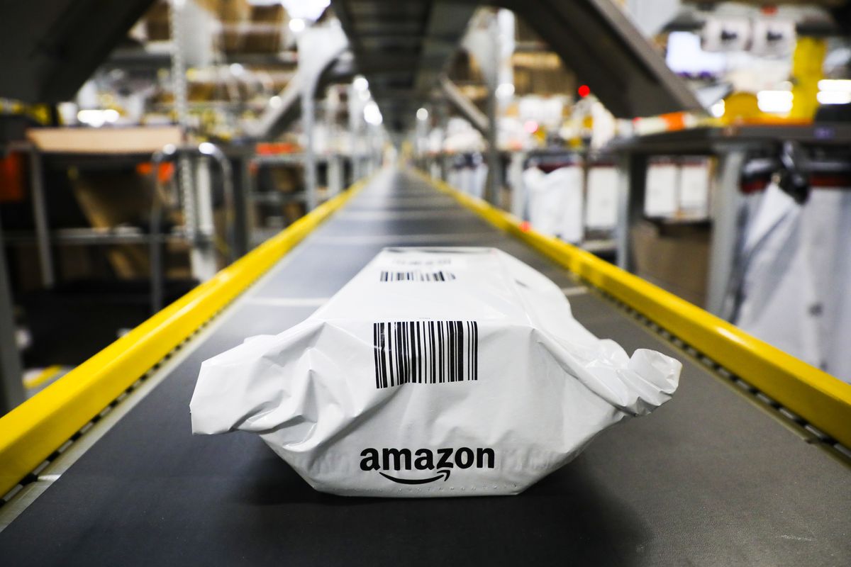 Amazon package on conveyor belt in a warehouse, highlighting logistics efficiency.