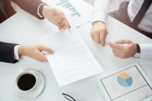 Two business professionals reviewing documents and discussing category management processes.