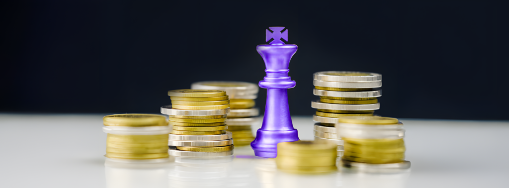 Purple chess king standing over stacks of gold and silver coins, symbolizing "Cash is King" concept.